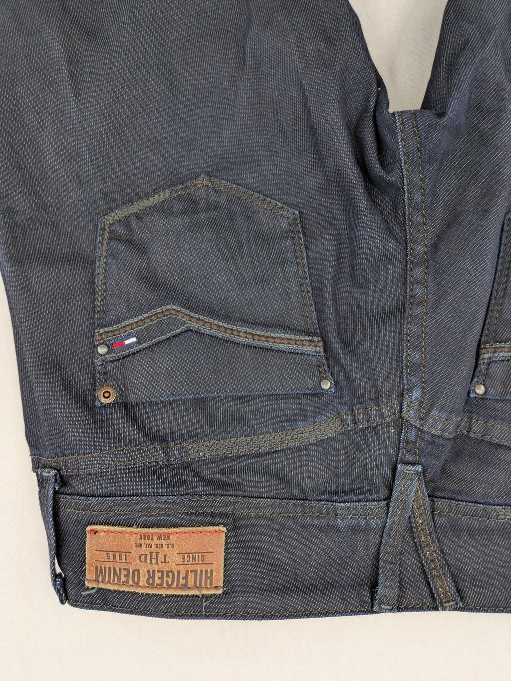Hilfiger Denim blue straight jeans with double button closure and logo detail.
