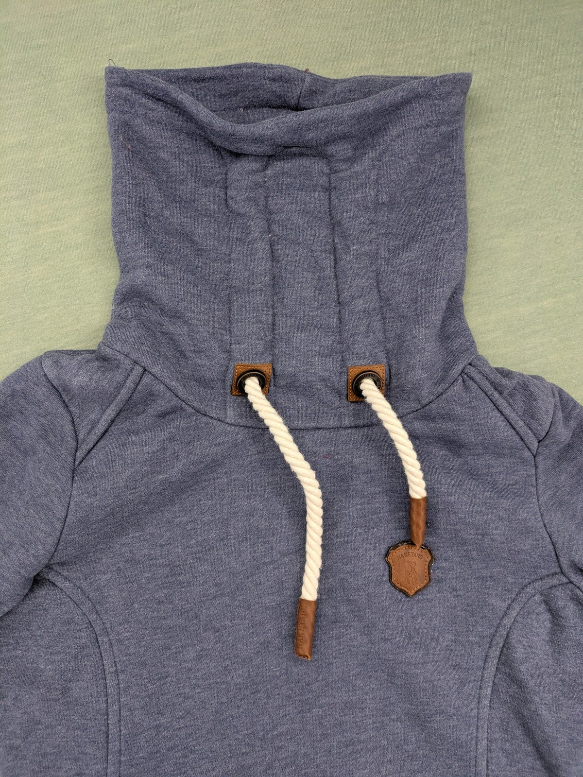 Naketano grey turtle neck jumper with thick drawstring and leather logo appliqué.
