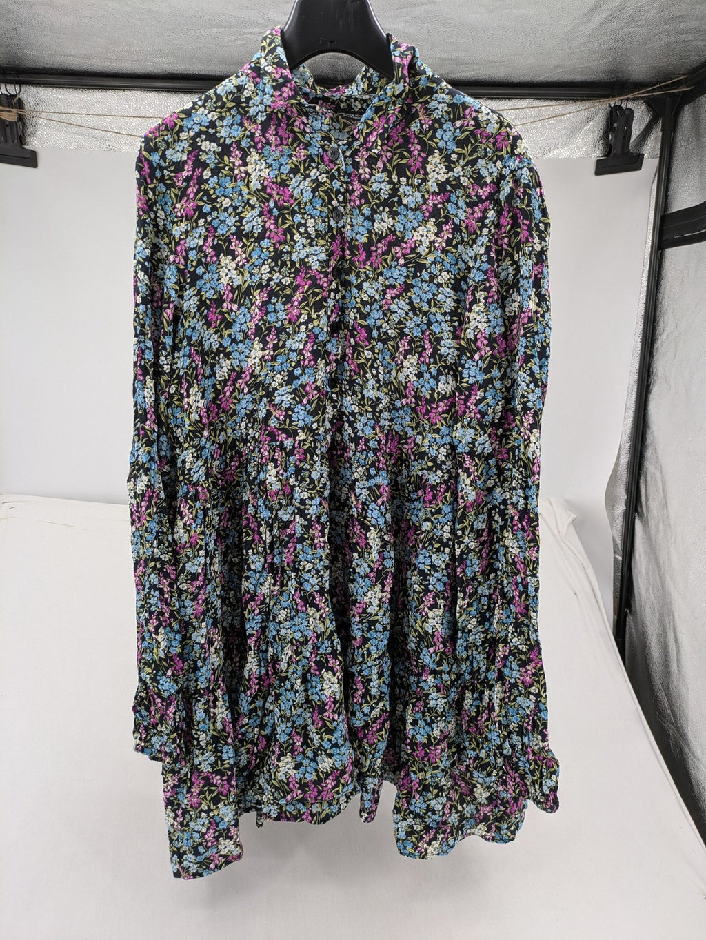Zara multi-coloured floral mini dress with classic collar and button placket on black background.