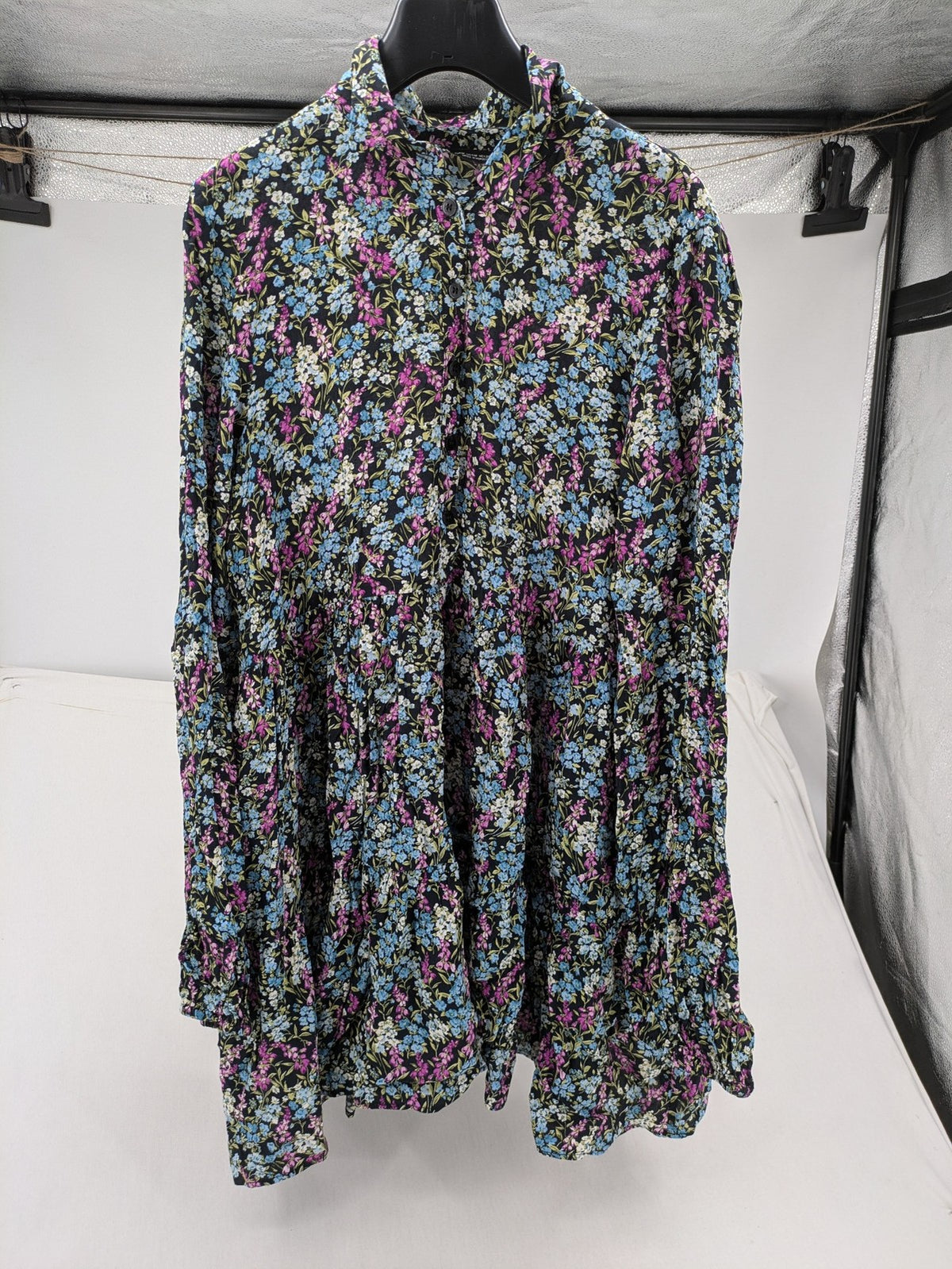 Zara multi-coloured floral mini dress with classic collar and button placket on black background.