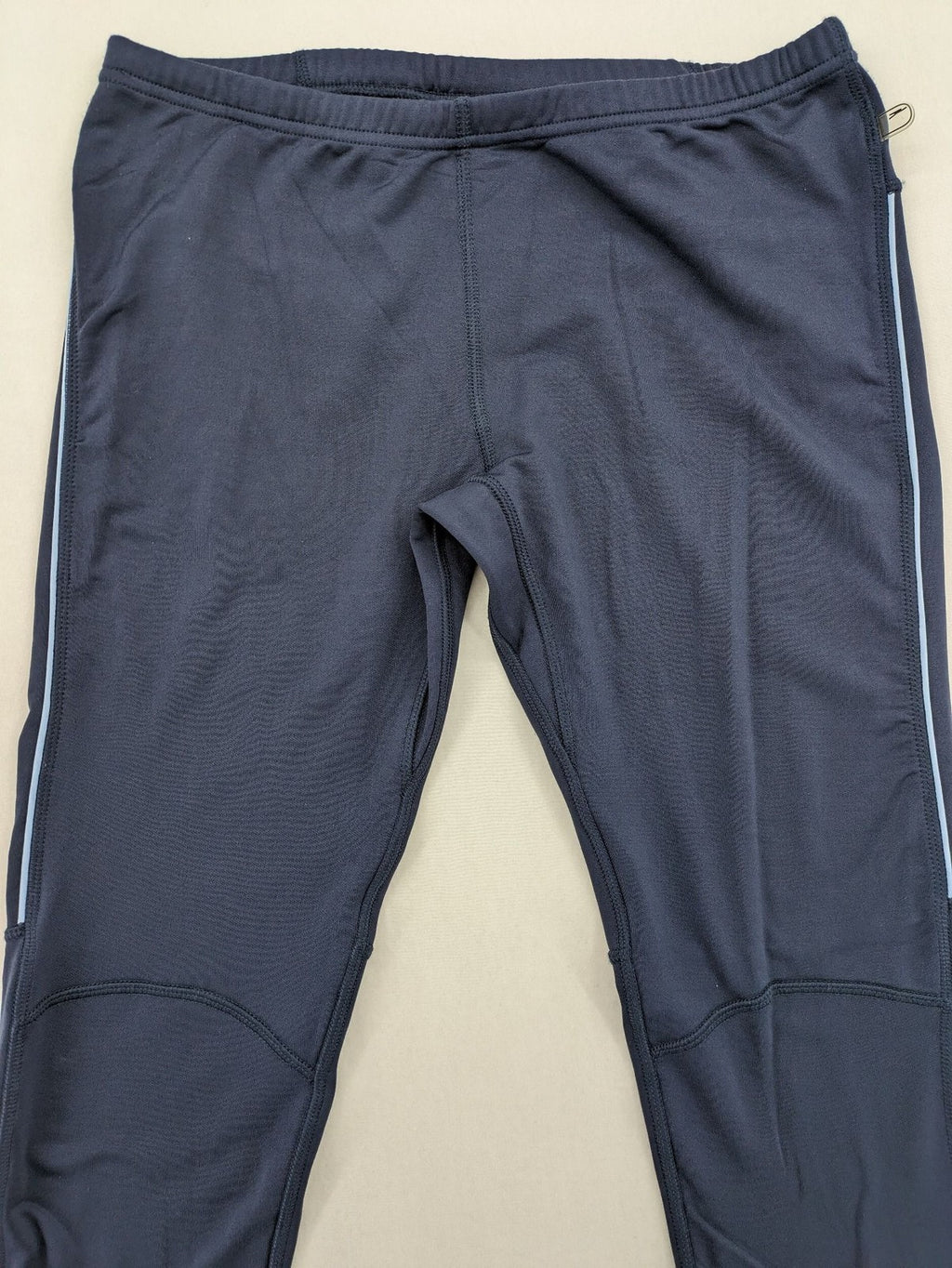 Crane Sports navy running tights with reflective details and zippered ankle openings.