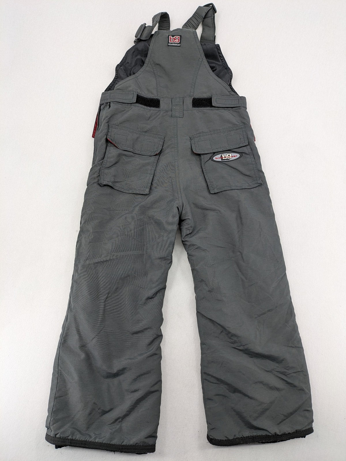 H&M grey snow pants with red accents, adjustable straps, and multiple cargo pockets.