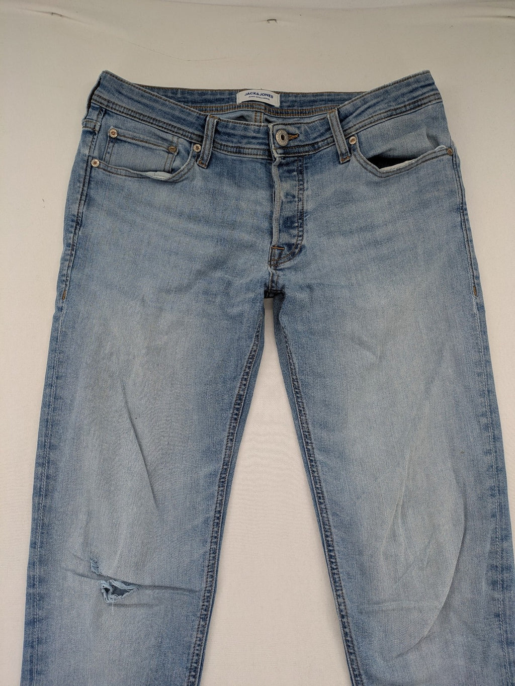 Jack & Jones blue slim jeans with button fly and subtle used look.