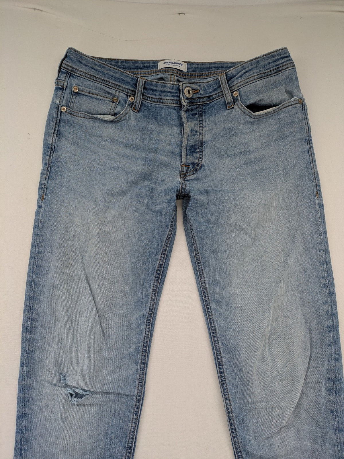 Jack & Jones blue slim jeans with button fly and subtle used look.
