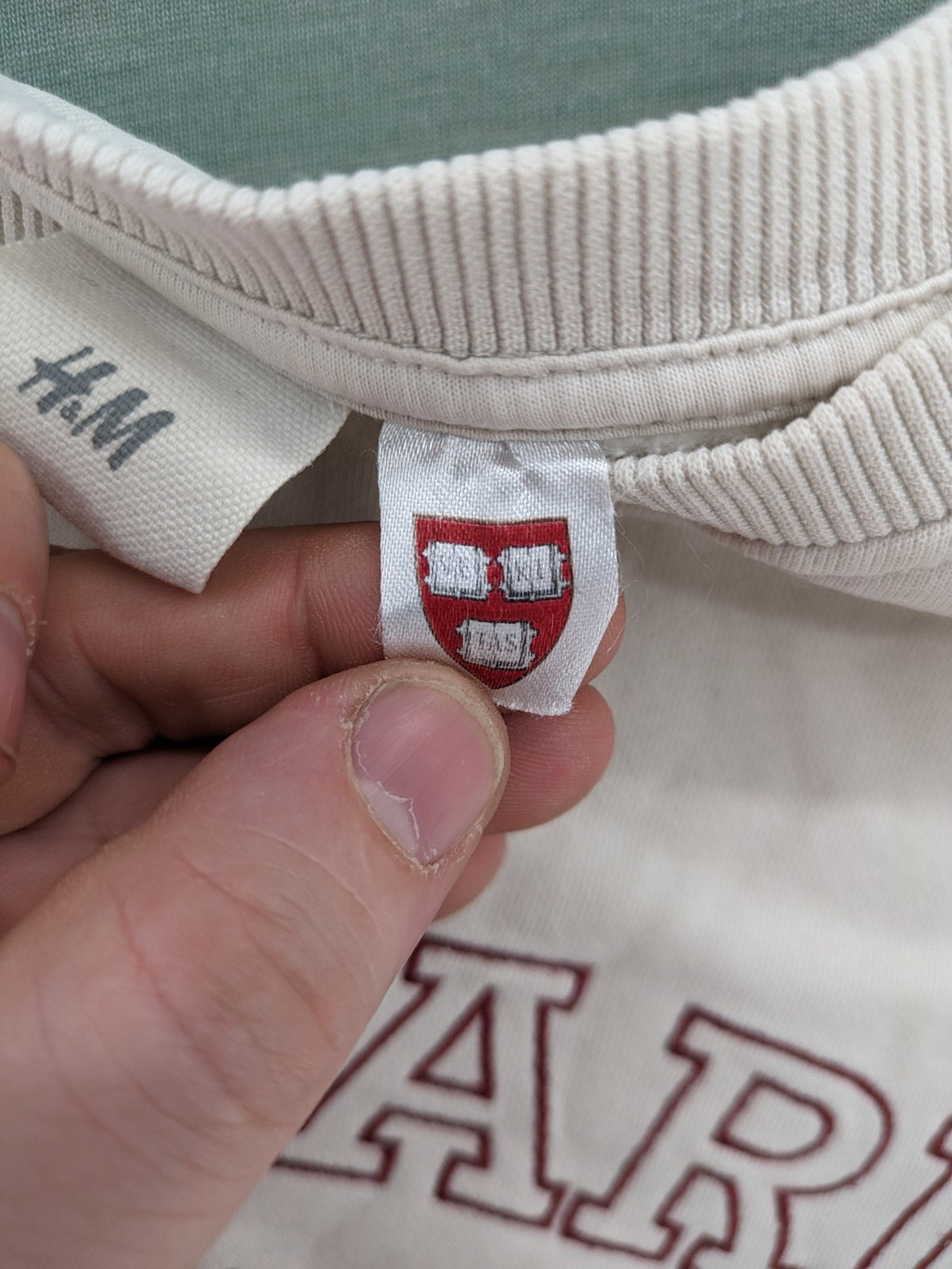 H&M cream turtle neck jumper embroidered Harvard University logo, soft cotton blend.