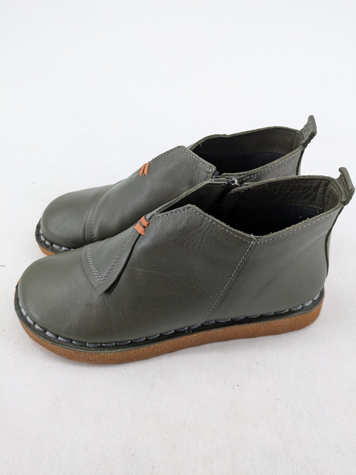 ALS green leather booties with side zipper and decorative stitching.