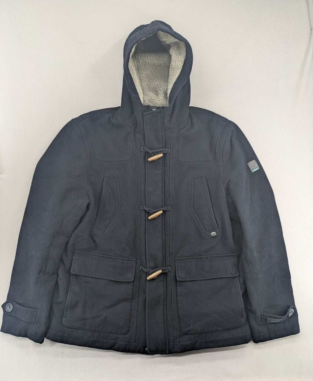 Angelo Litrico black duffle coat with toggle closure and cream Sherpa-lined hood.
