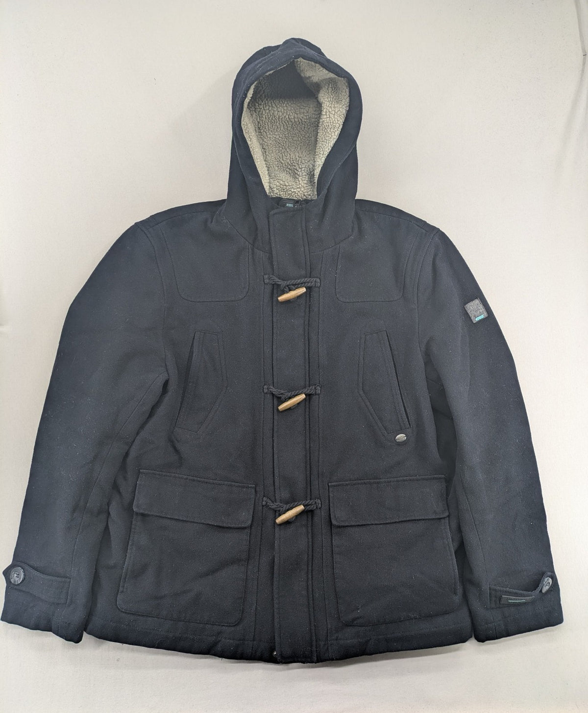 Angelo Litrico black duffle coat with toggle closure and cream Sherpa-lined hood.