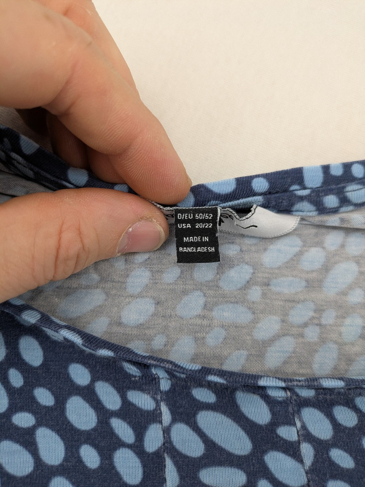 Ulla Popken blue tunic top with light blue polka dots and A-line cut.