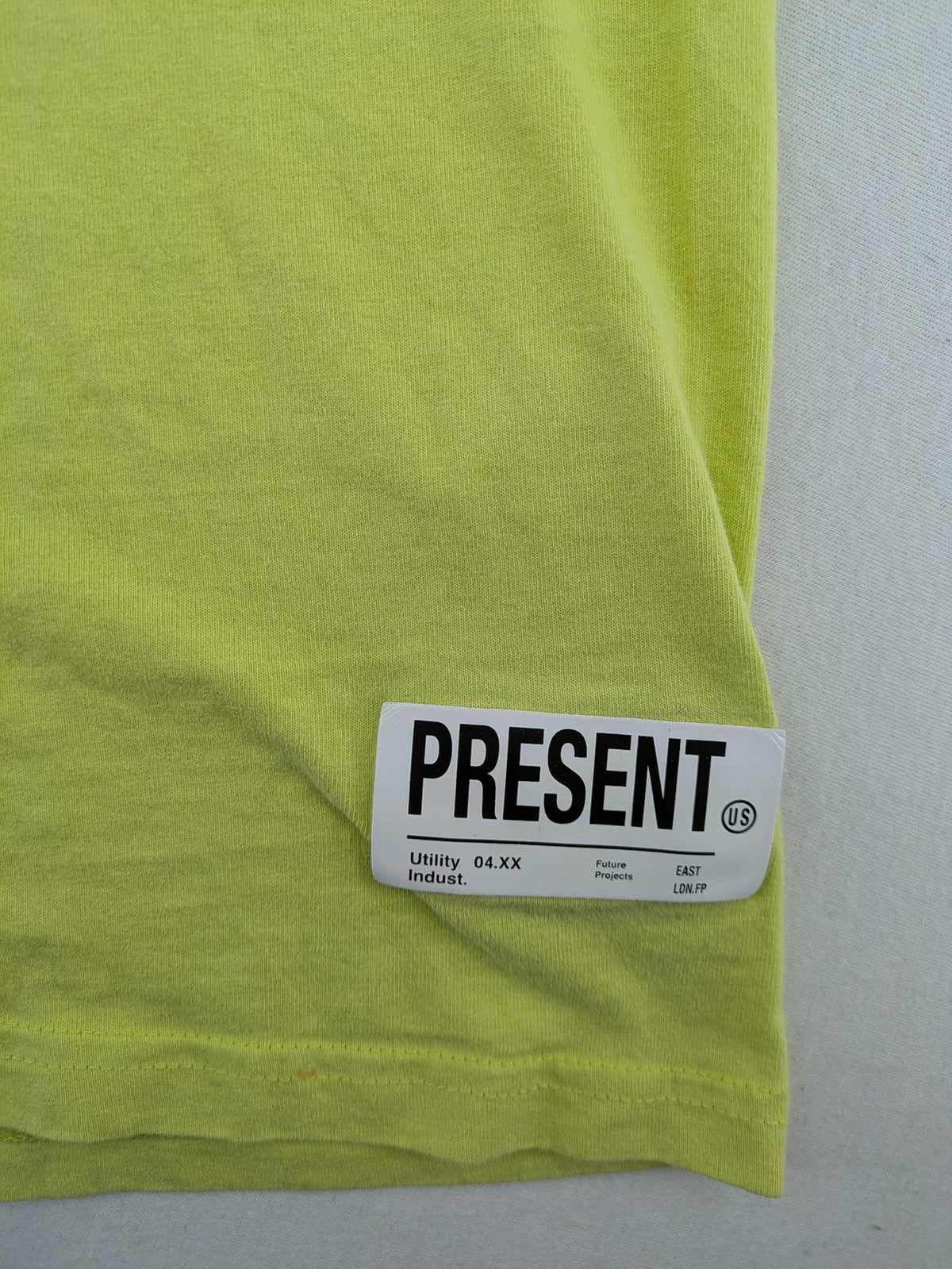 Primark yellow band t-shirt featuring Gothic LA graphic print and "PRESENT" patch.