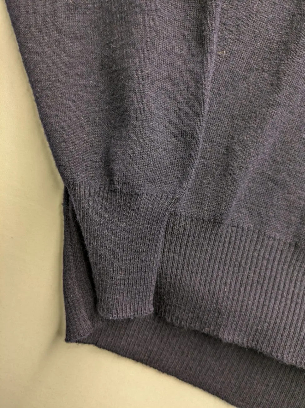 Il Granchio grey turtle neck jumper with red accents and embroidered crab logo.