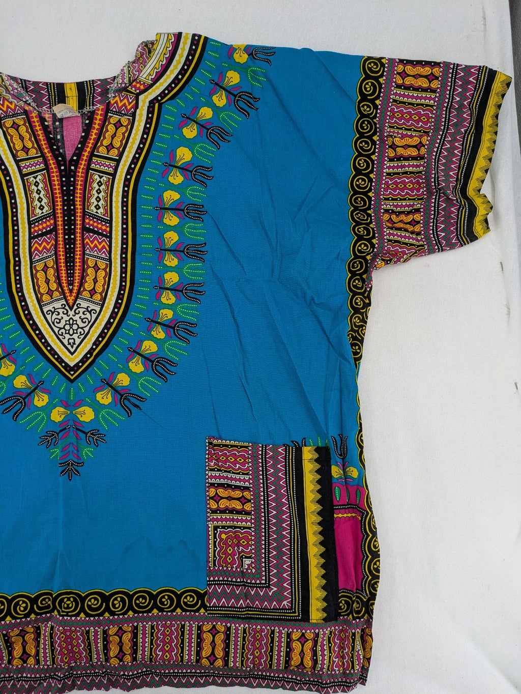 M/L multi Dashiki shirt with vibrant ethnic print on light blue cotton fabric.