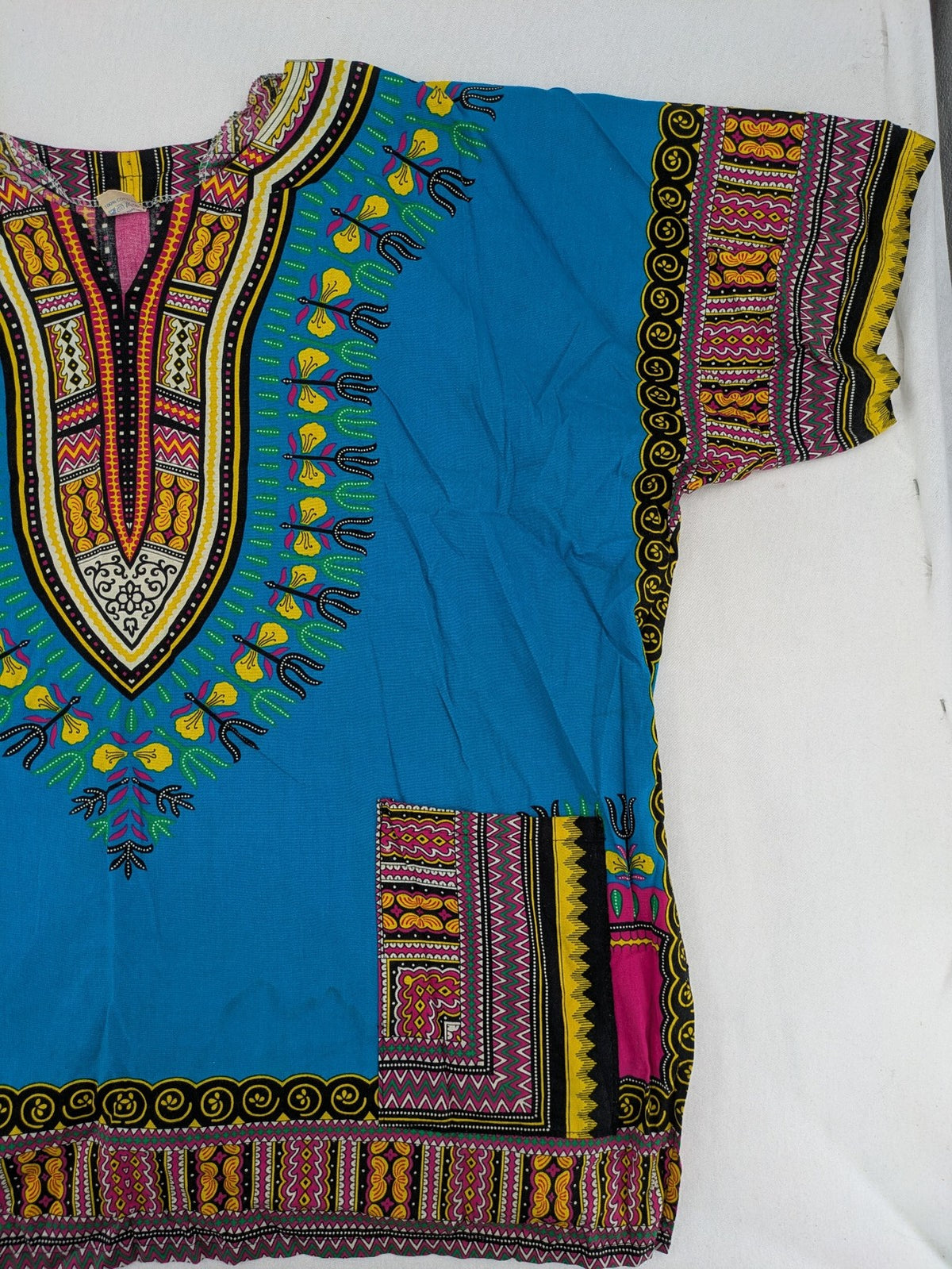 M/L multi Dashiki shirt with vibrant ethnic print on light blue cotton fabric.