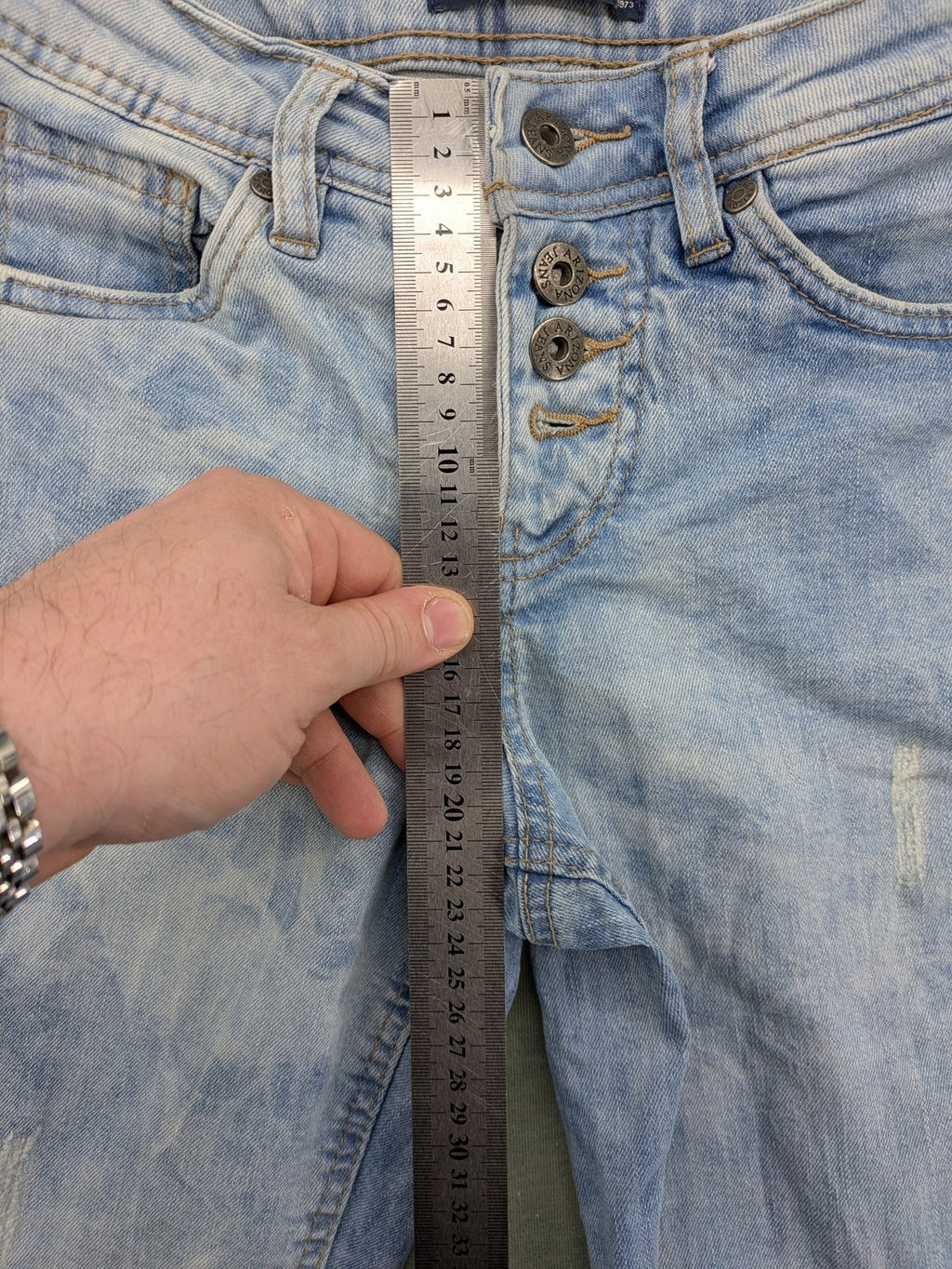 Arizona blue flare jeans with acid wash, button fly, and stretch denim material.