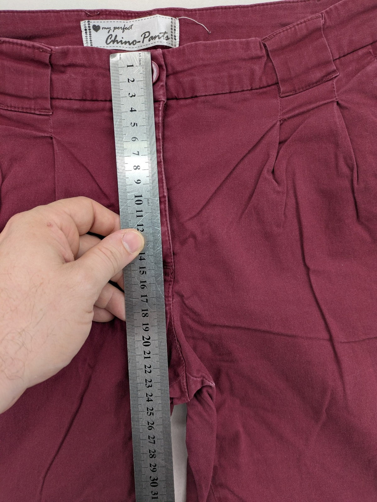 BPC Bonprix burgundy chino pants with front pleats and floral pocket lining.
