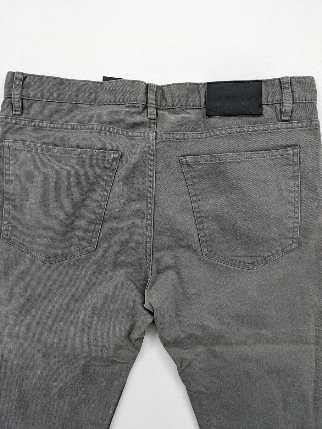 H&M grey skinny fit jeans with button closure and five-pocket design, cotton-elastane blend.