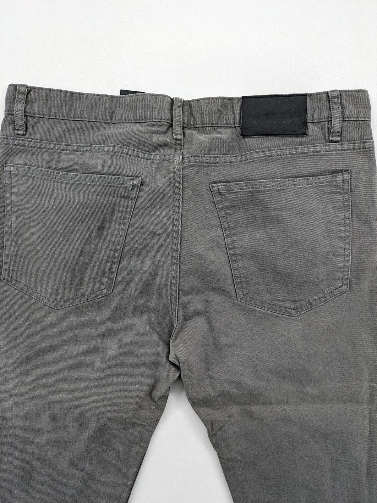 H&M grey skinny fit jeans with button closure and five-pocket design, cotton-elastane blend.