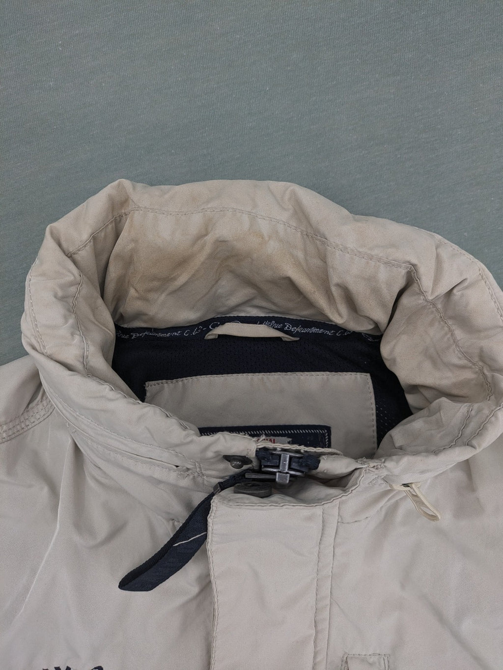Camp David beige field jacket with logo patches, standing collar, and multiple pockets.