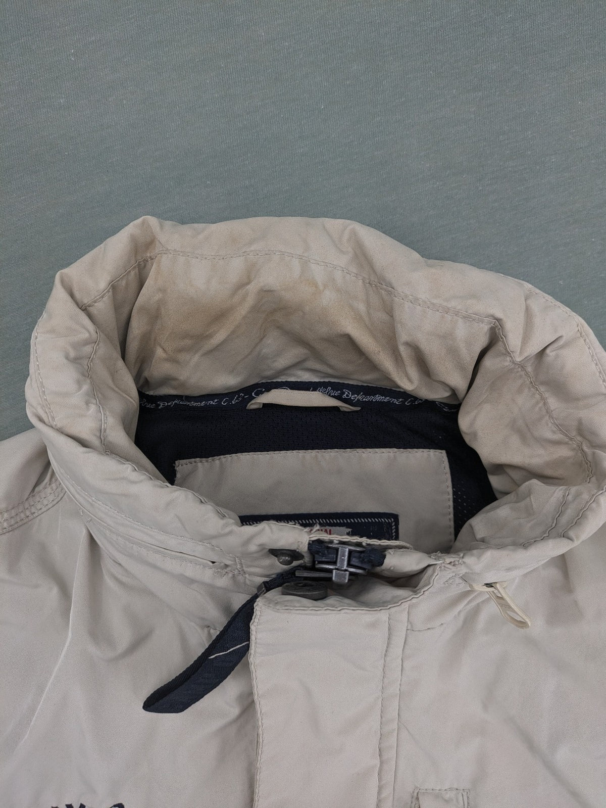 Camp David beige field jacket with logo patches, standing collar, and multiple pockets.