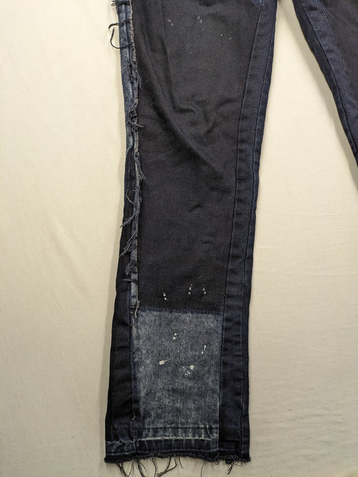 Reternity straight jeans blue black patchwork design with distressed details and frayed seams.