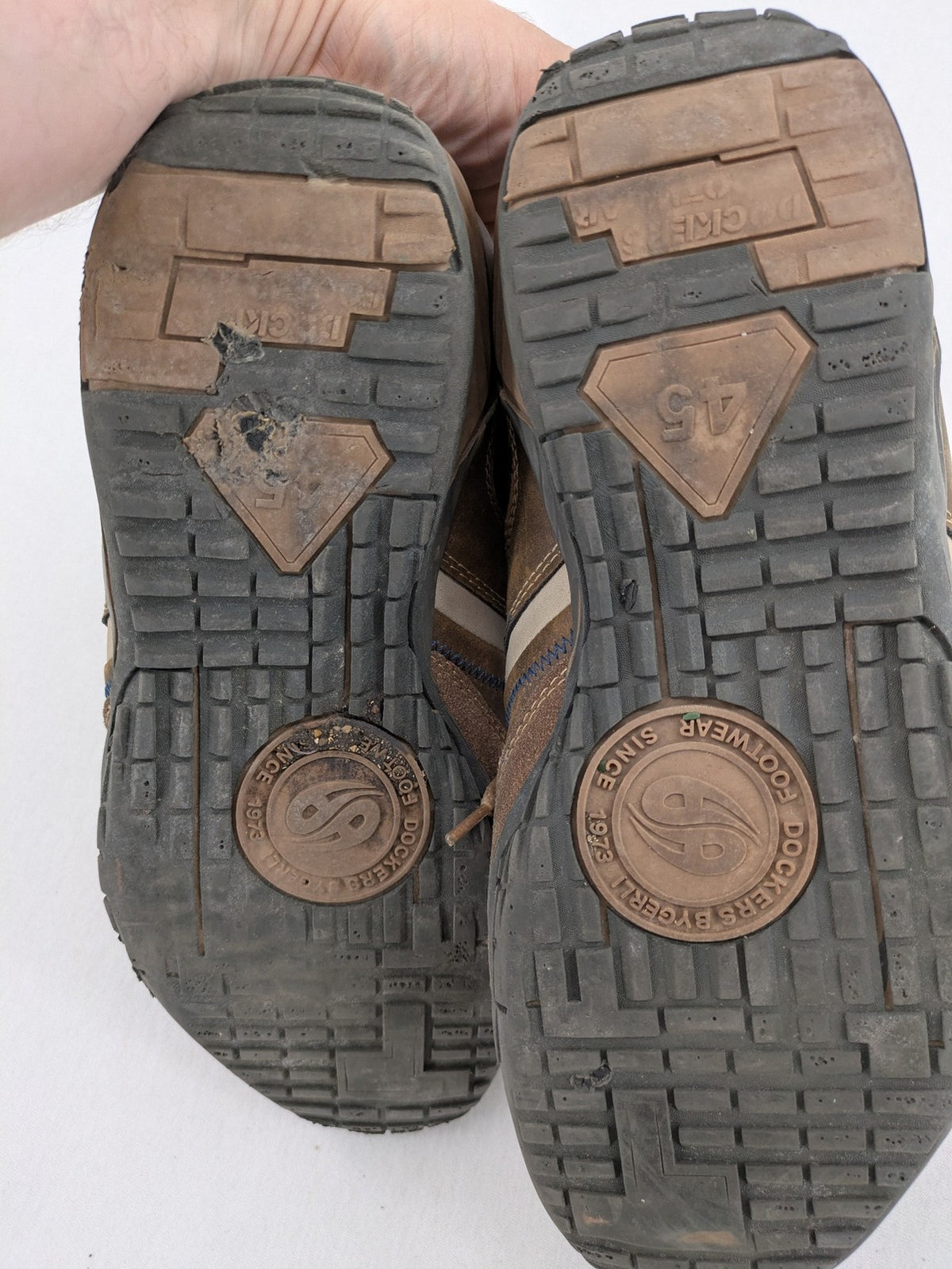 Dockers brown sneakers with subtle light brown and blue accents, lace-up design.
