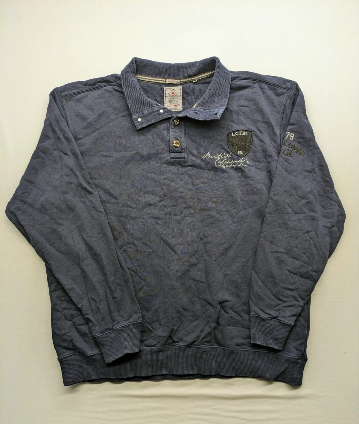 Lerros blue turtle neck jumper with stitched 'British Columbia' detail and button accents.