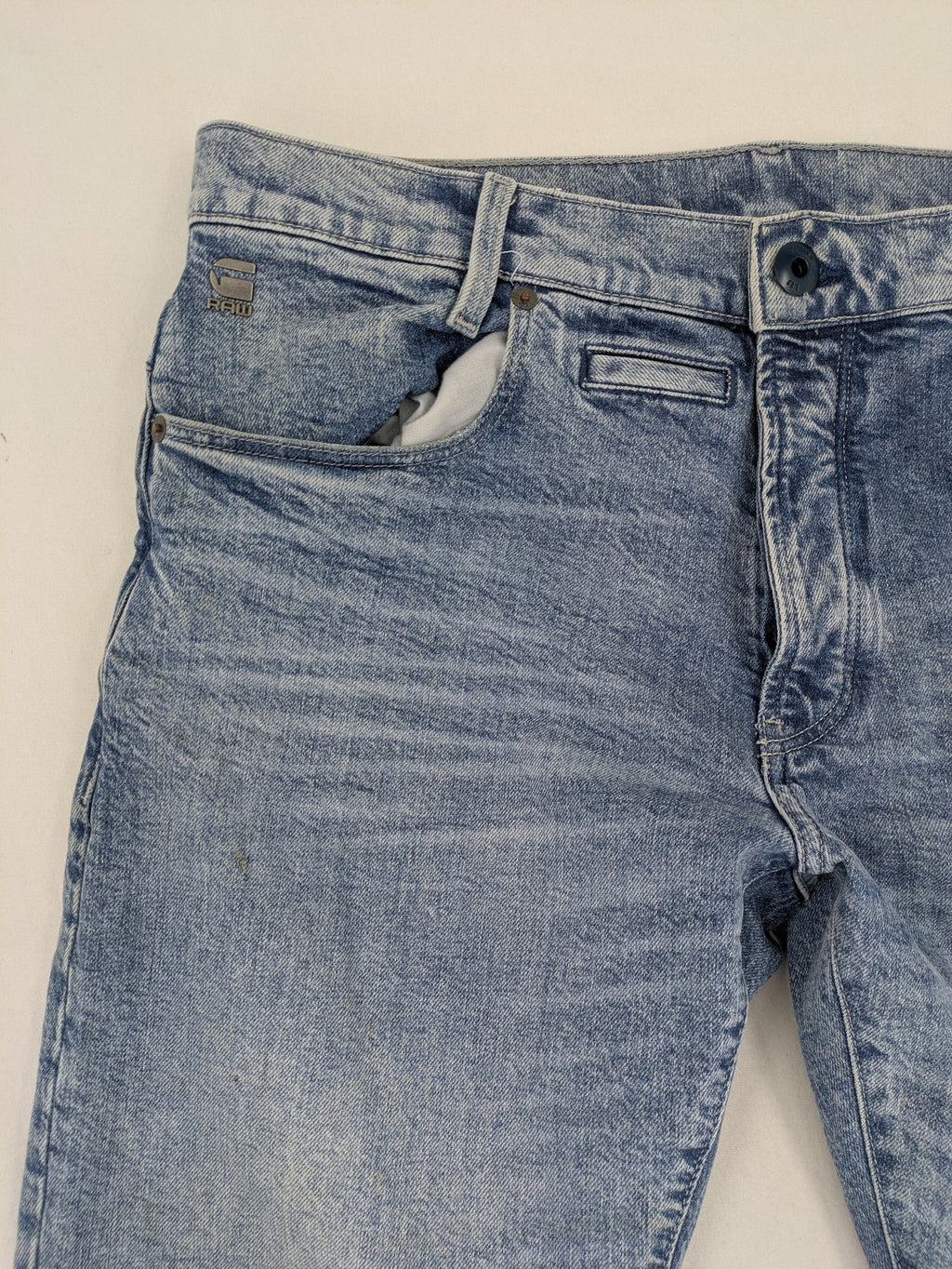 G-Star Raw blue slim fit jeans with 5-pocket design and light wash denim.