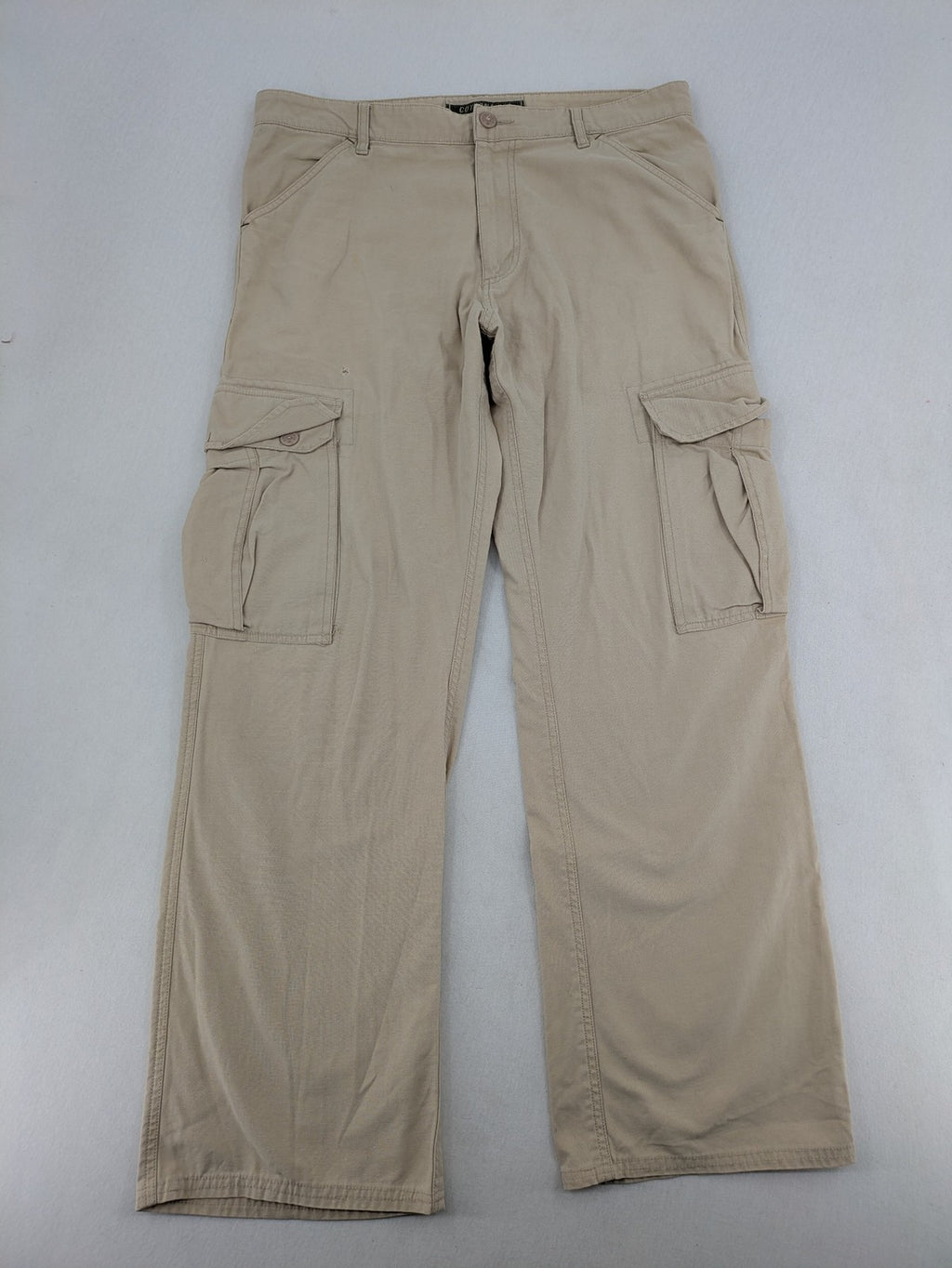 Cottonfield beige cargo pants with multiple pockets and button flaps.