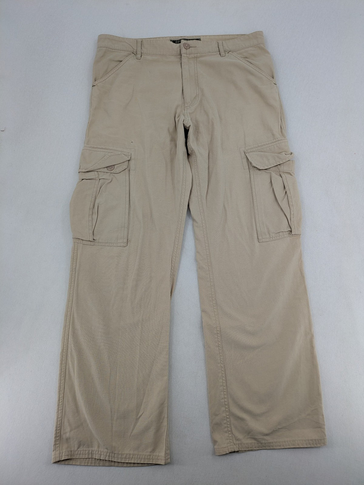Cottonfield beige cargo pants with multiple pockets and button flaps.