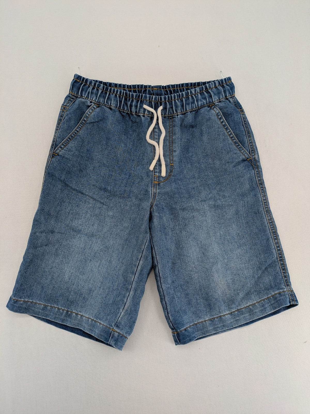 C&A blue denim shorts with elastic waistband and decorative drawstring, classic style.