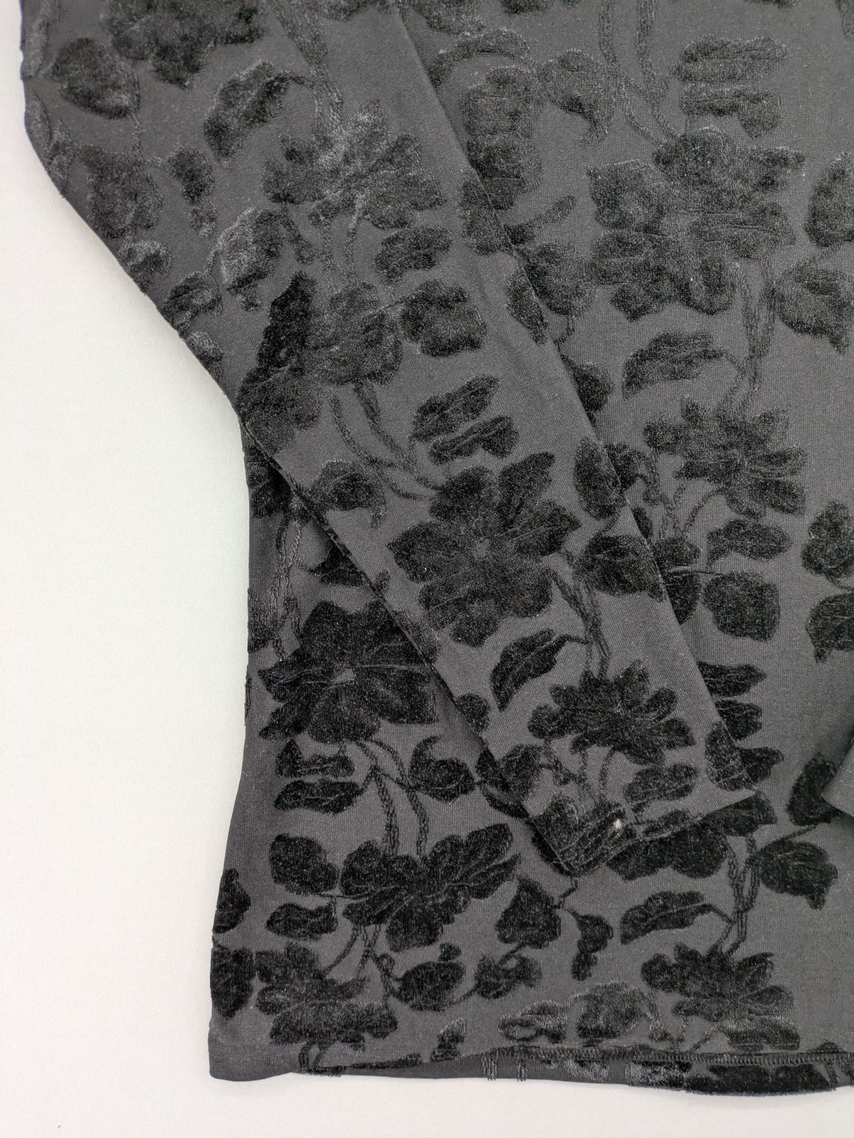 TCM black long sleeve top with floral flock print on sheer fabric.