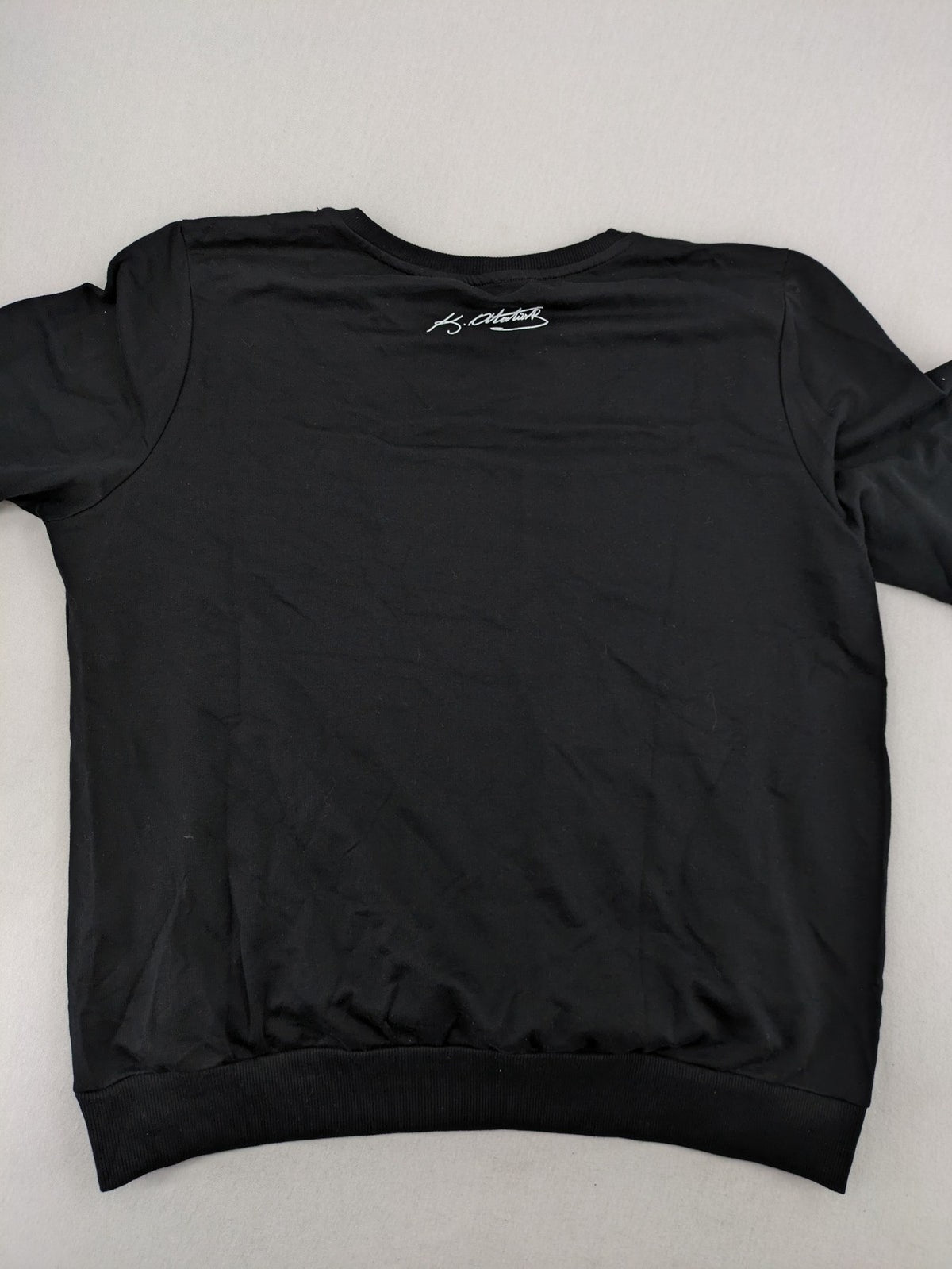 LC Waikiki black turtle neck jumper featuring Atatürk graphic print and signature.