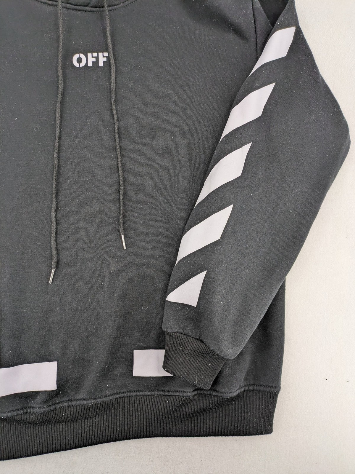 Off-White white zip-through hoodie with diagonal stripes and large arrows graphic.