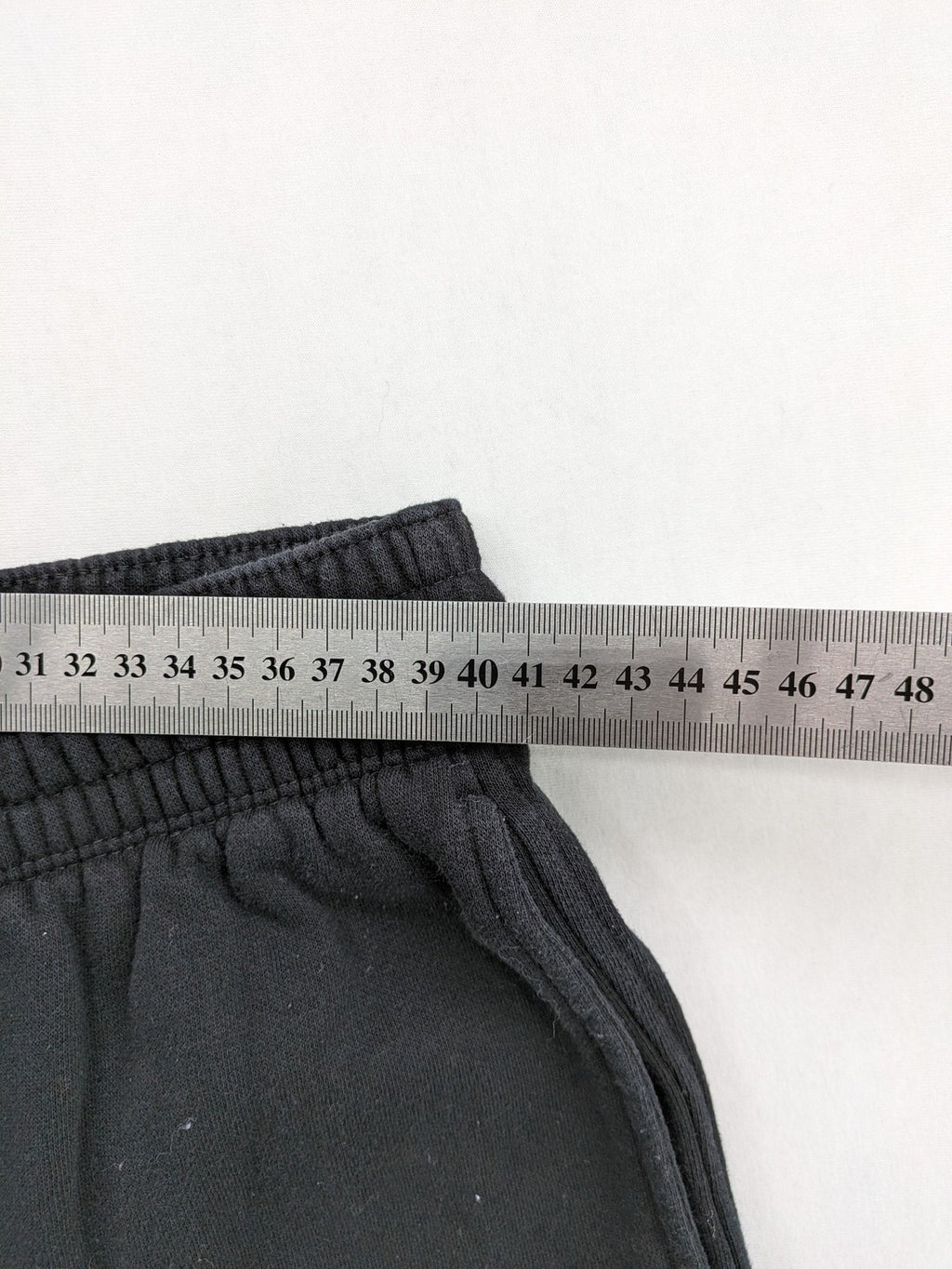 H&M black sweatpants with adjustable drawstring, elastic cuffs, and side pockets.