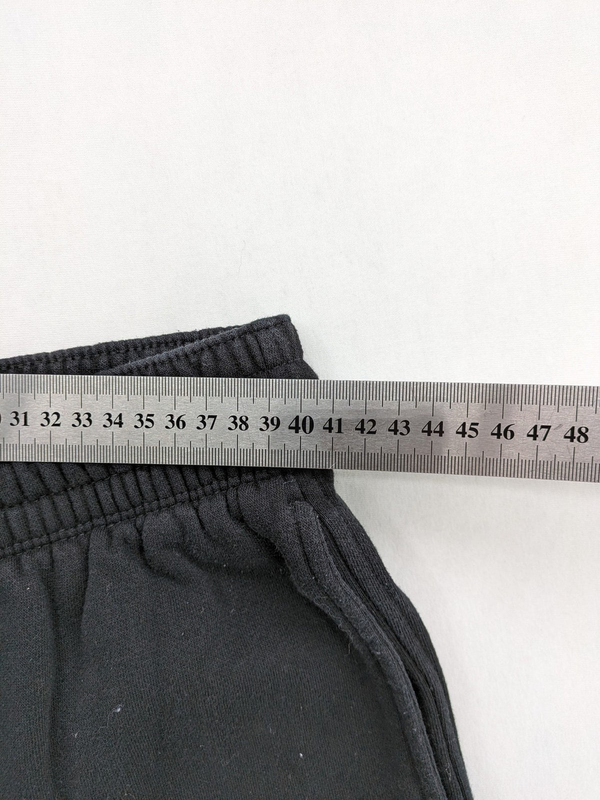 H&M black sweatpants with adjustable drawstring, elastic cuffs, and side pockets.