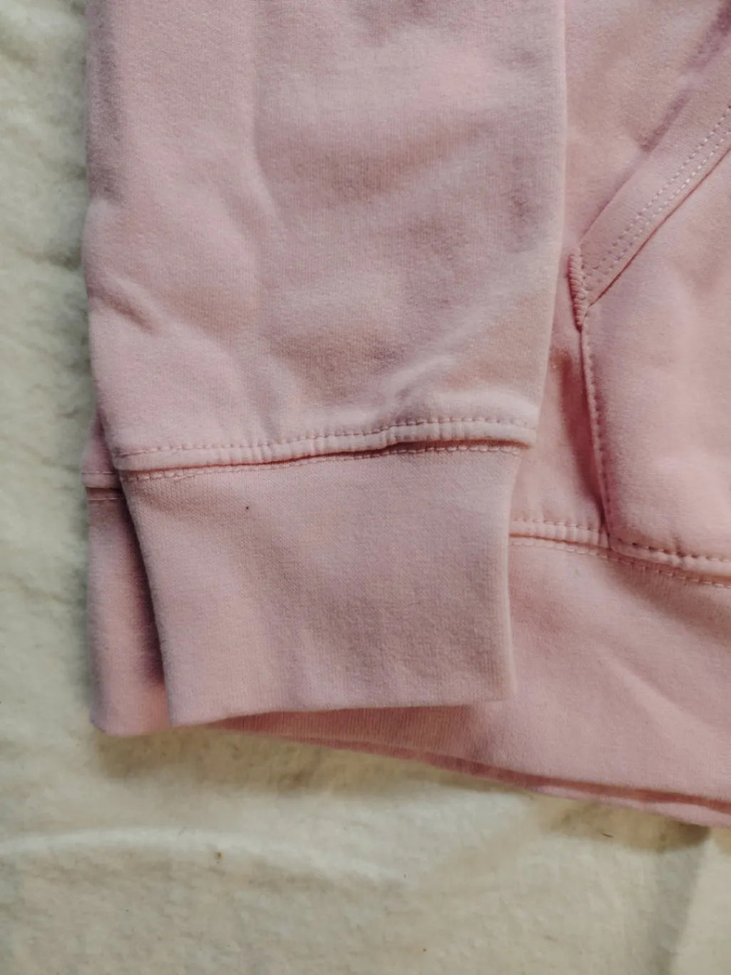 Just Hoods pink zip-through hoodie with "Trinkerbell" graphic, kangaroo pocket, drawstring hood.