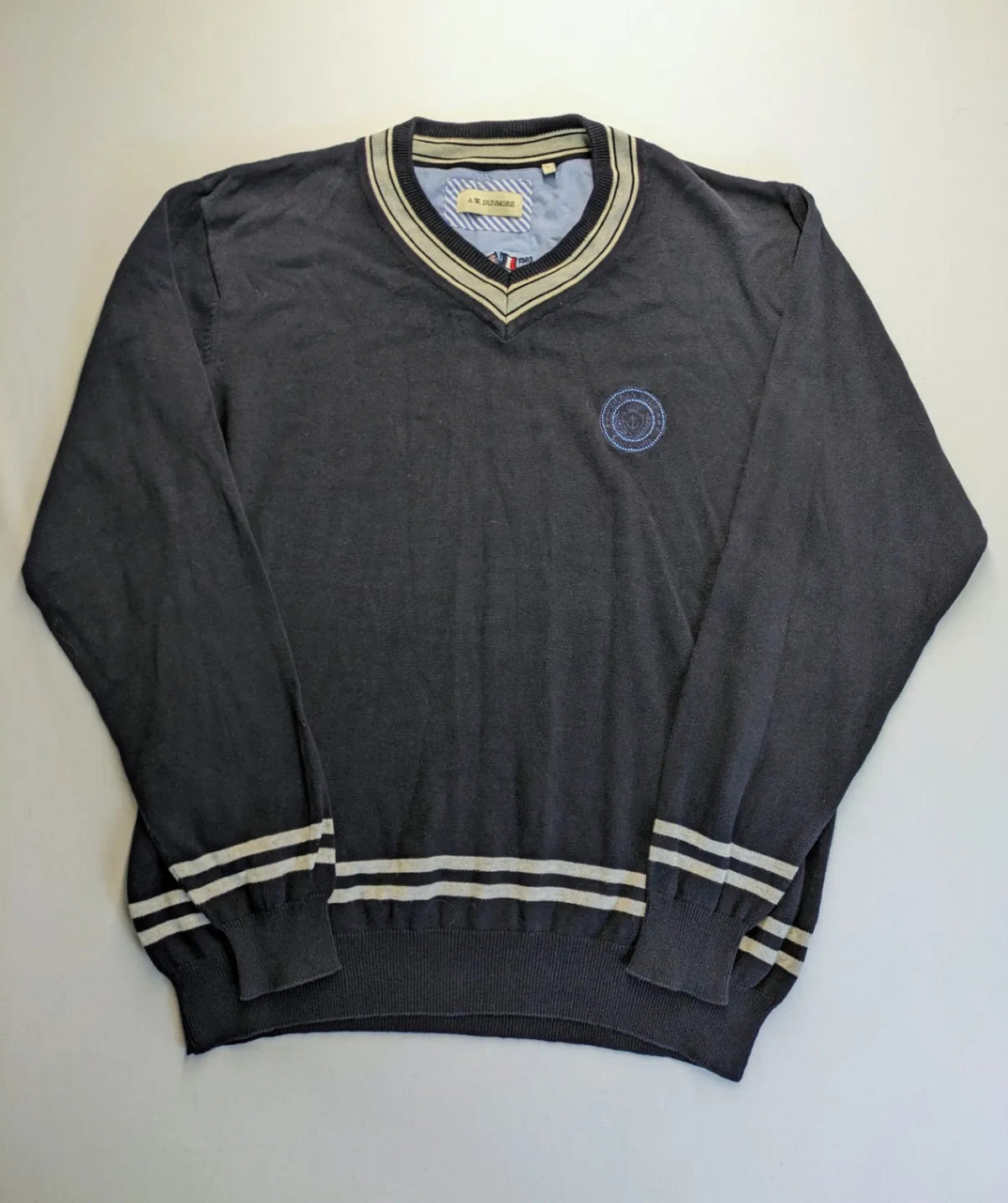 dunmore turtle neck jumper dark blue with striped trims and embroidered crest logo