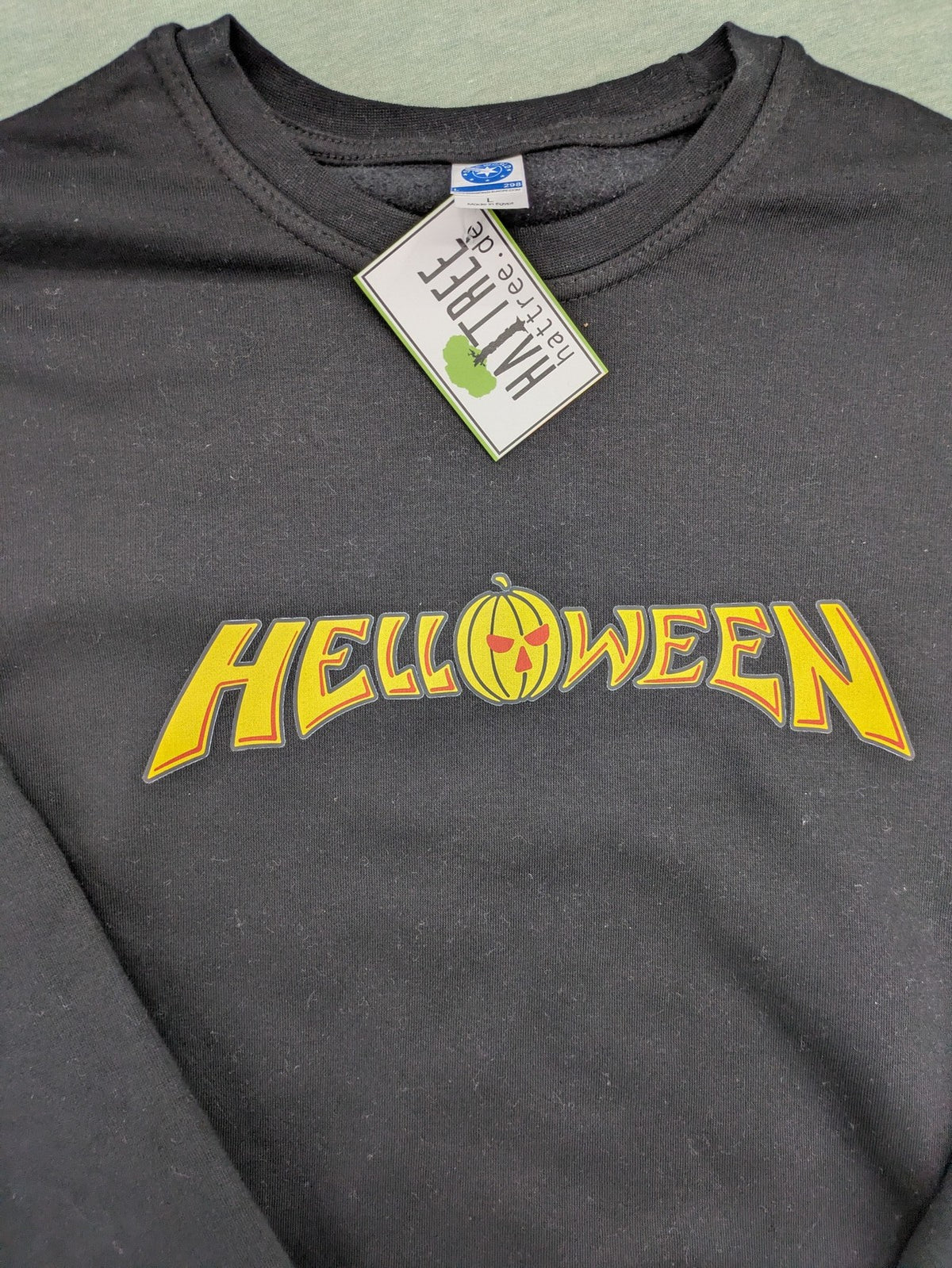 Helloween grey sweatshirt featuring bright yellow pumpkin logo, made from cotton blend.