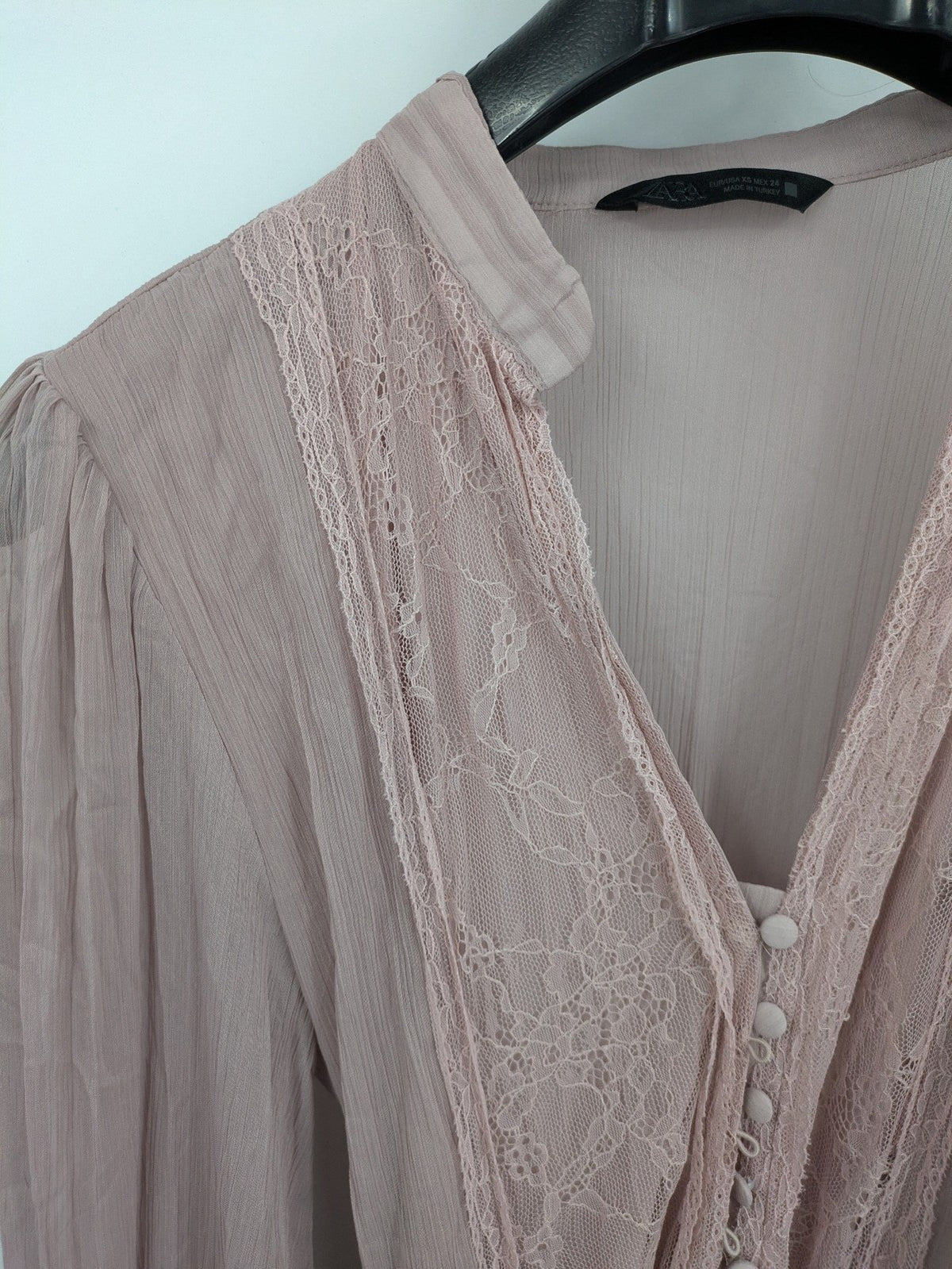 Zara pink midi dress with lace V-neck, pleated fabric, and long bishop sleeves.