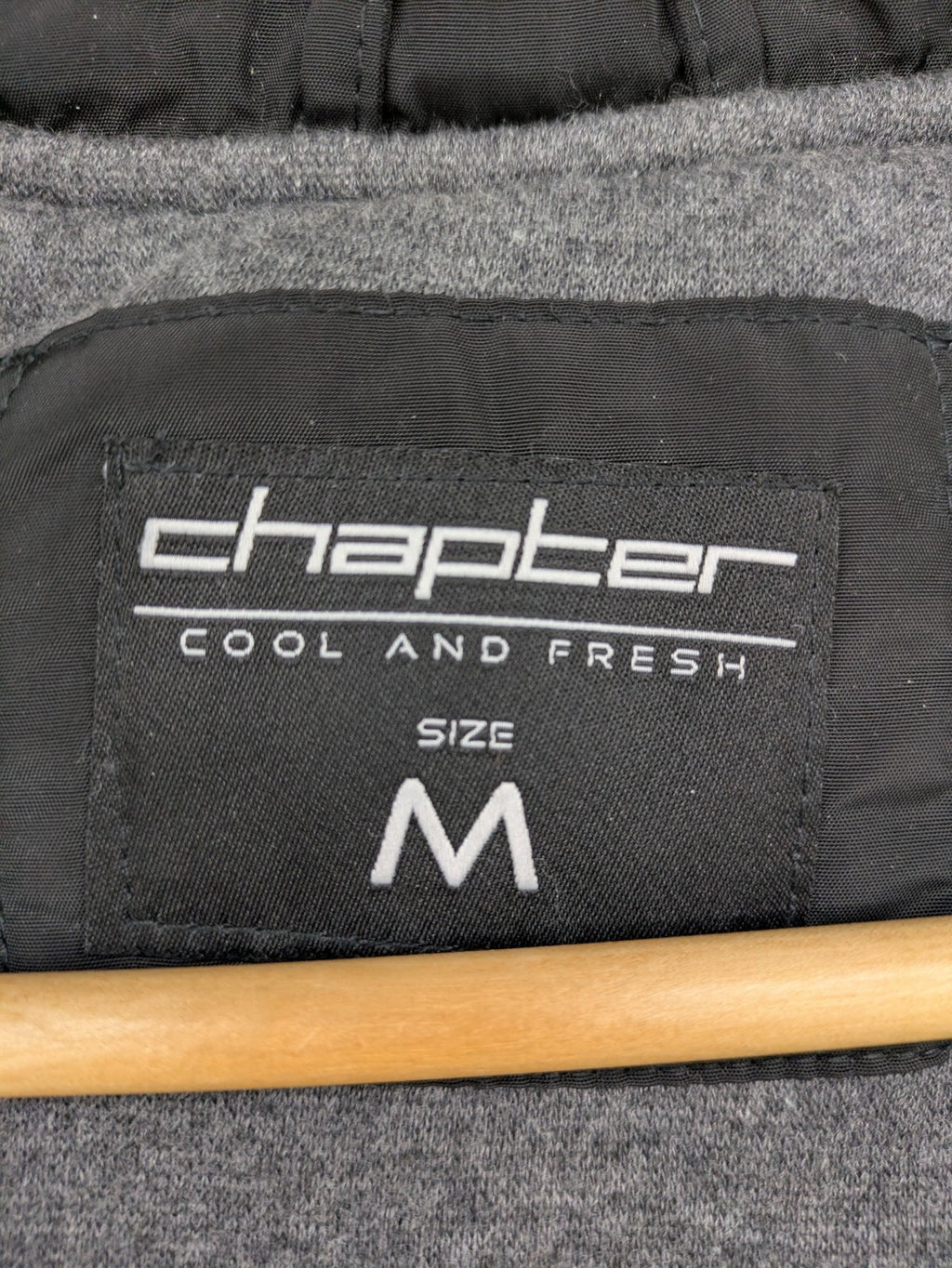 Chapter black bomber jacket with patches, striped ribbed cuffs, and full zip closure.