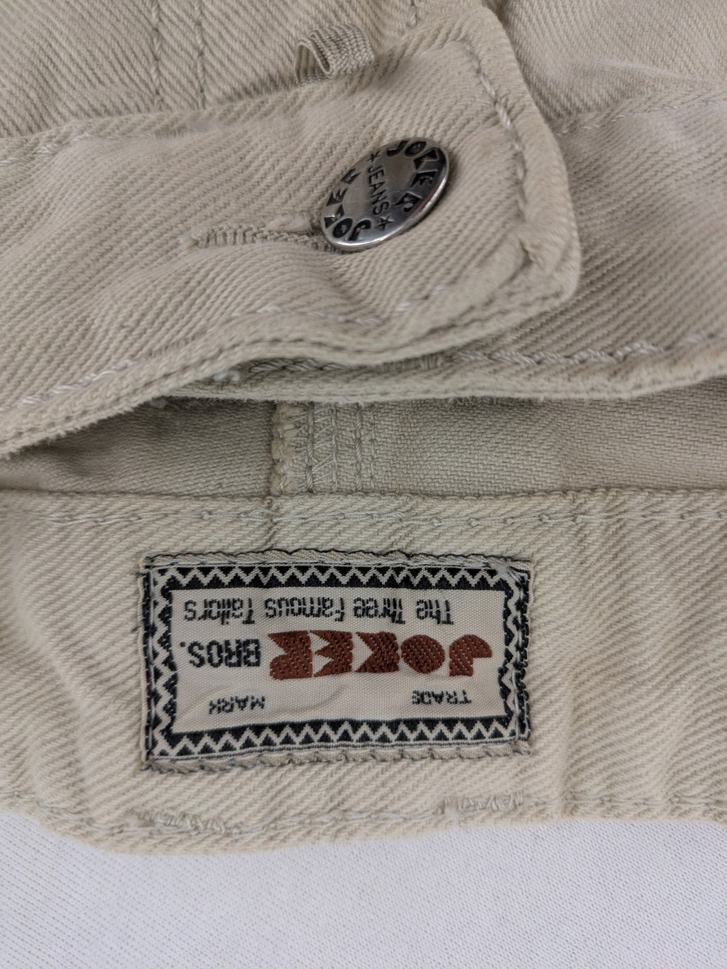 Joker beige straight jeans 5-pocket design with zipper and button closure.