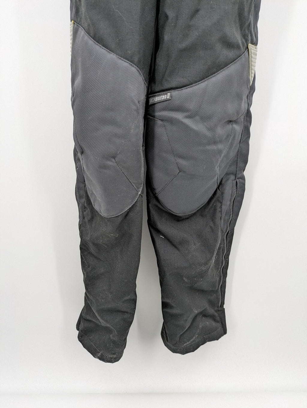 Hein Gericke black chaps with adjustable suspenders, made from durable Cordura and Kevlar.