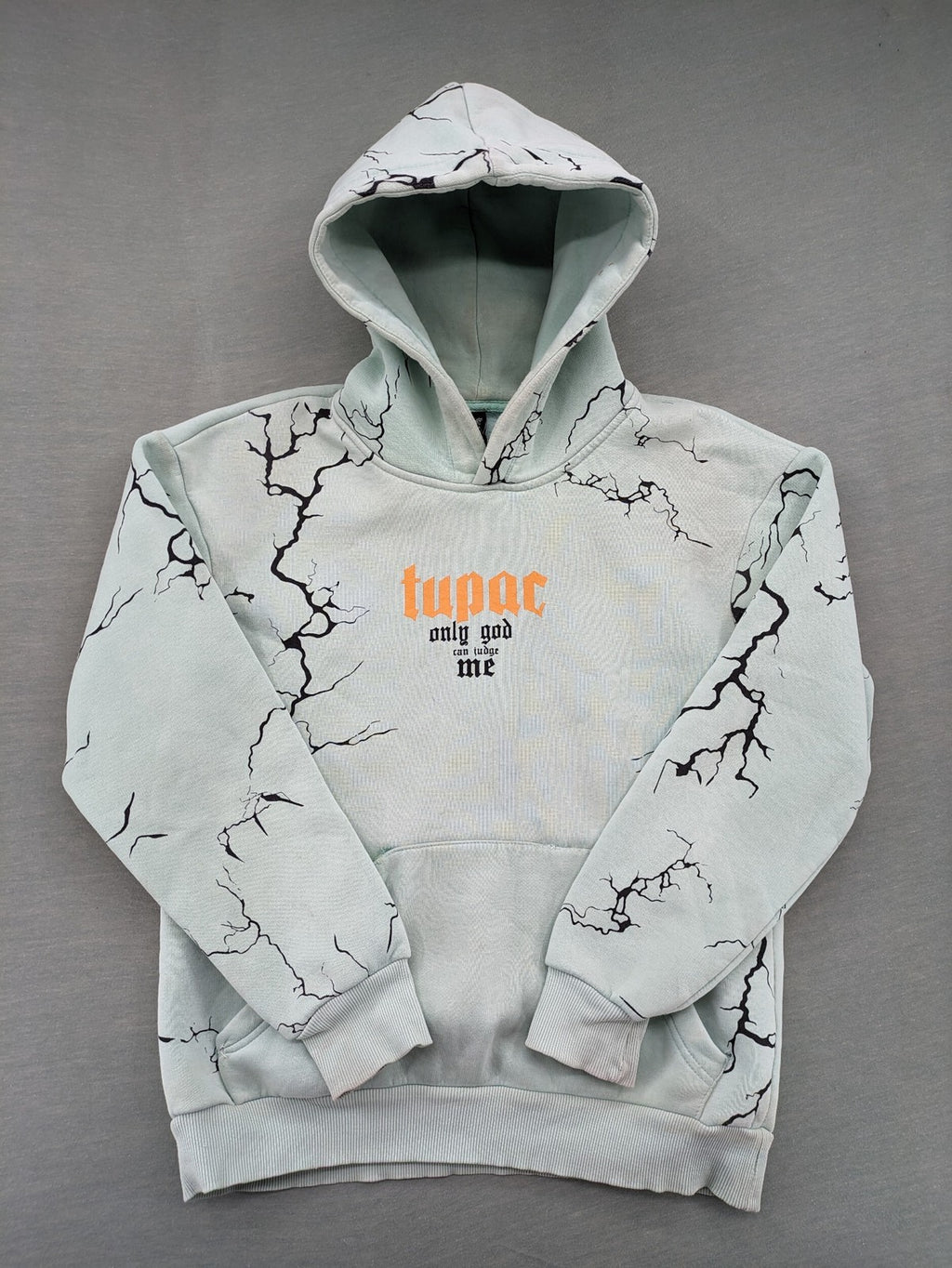 Tupac black and green zip-through hoodie with "Only God Can Judge Me" front print and angel wings graphic.