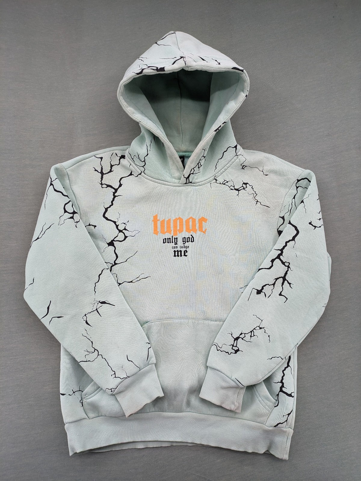 Tupac black and green zip-through hoodie with "Only God Can Judge Me" front print and angel wings graphic.