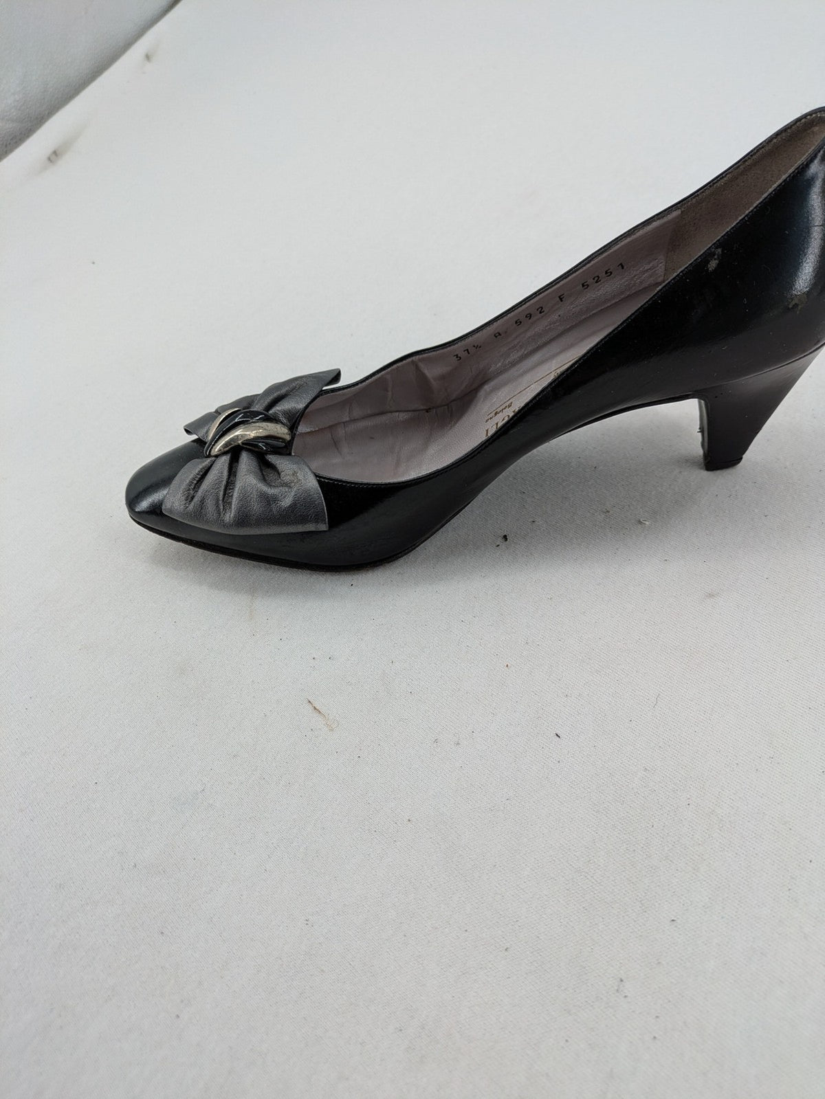 Bruno Magli black high heels leather with grey bow detail and classic silhouette.