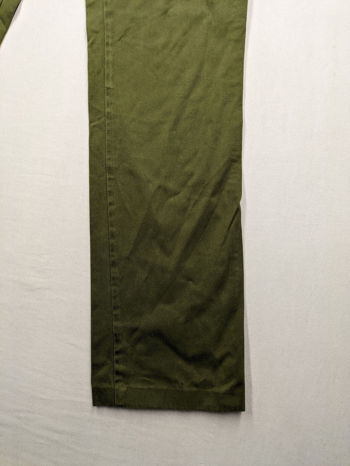 BRAX khaki pants classic five-pocket style with logo patch and zip button closure.