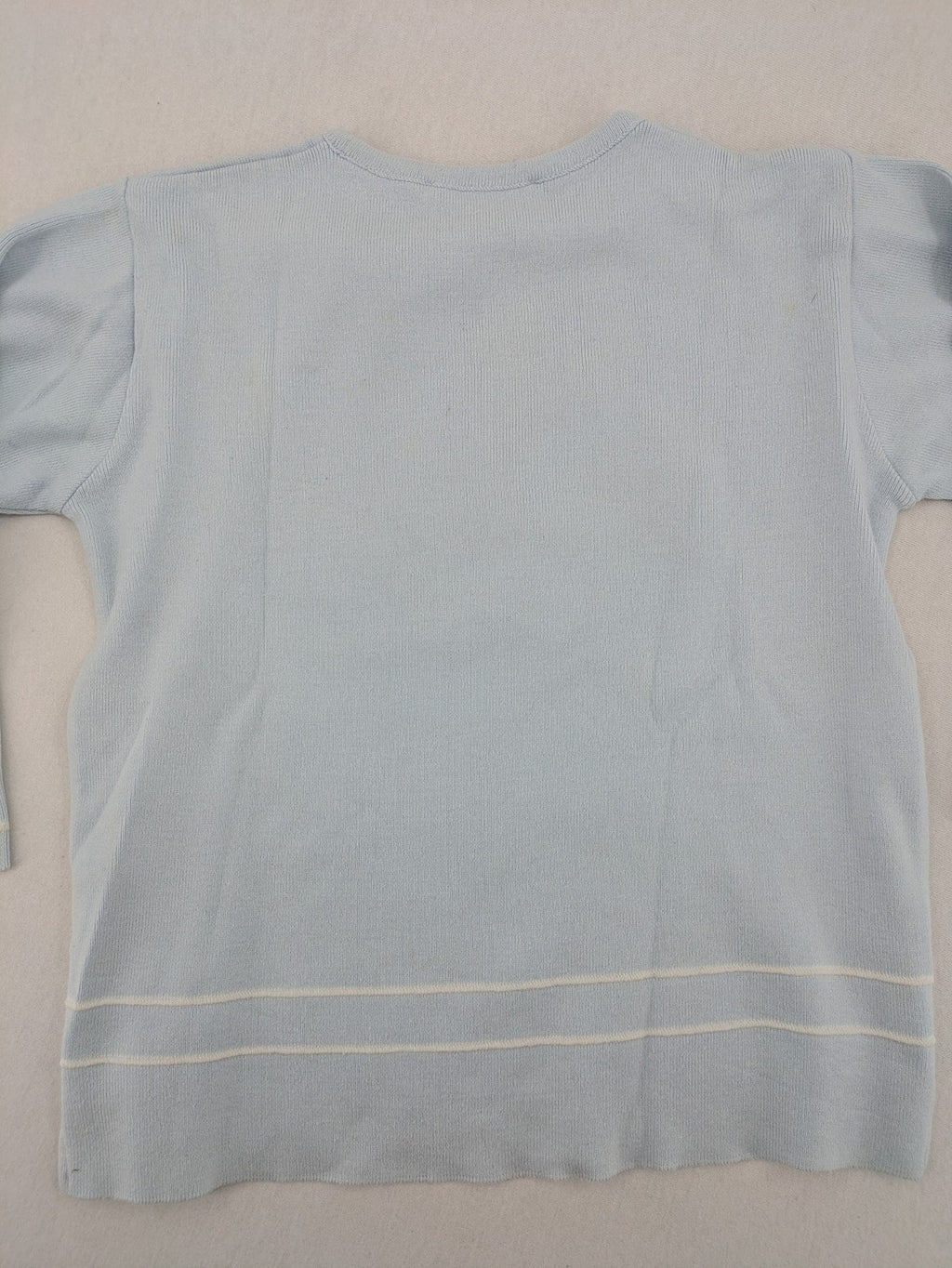 Donaldson multi turtle neck jumper light blue with embroidered Minnie Mouse graphic and ribbed texture.