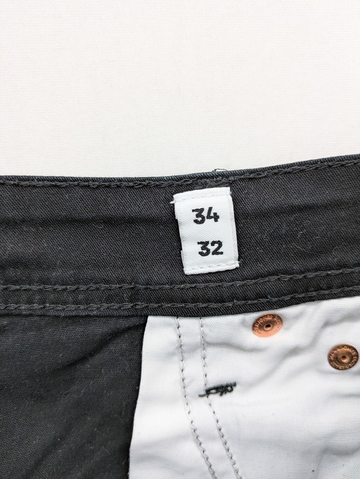 Jack & Jones black slim fit jeans with logo patch and cotton-stretch blend.