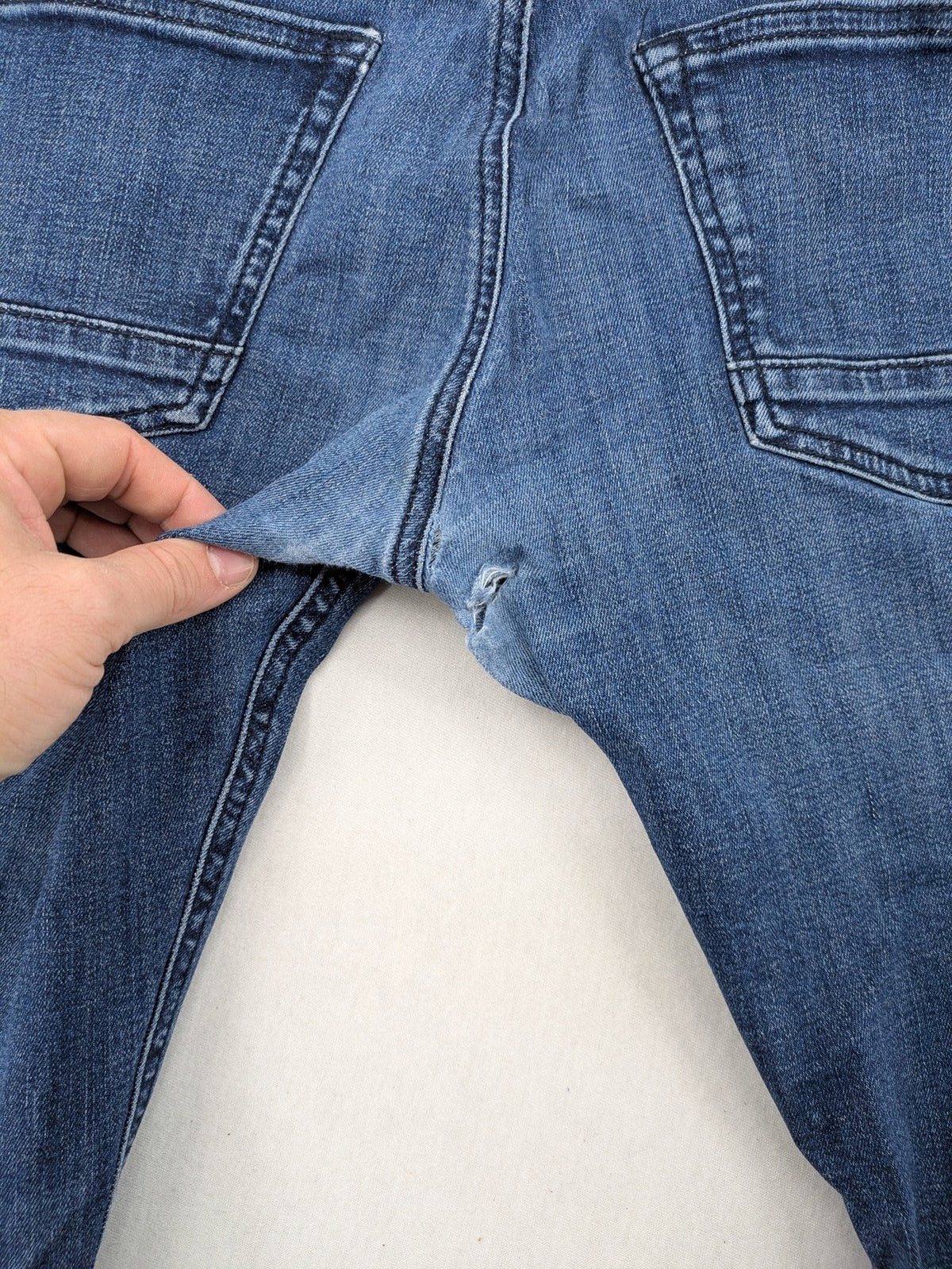 BOSS blue slim fit jeans with logo, five-pocket design, and button fly.