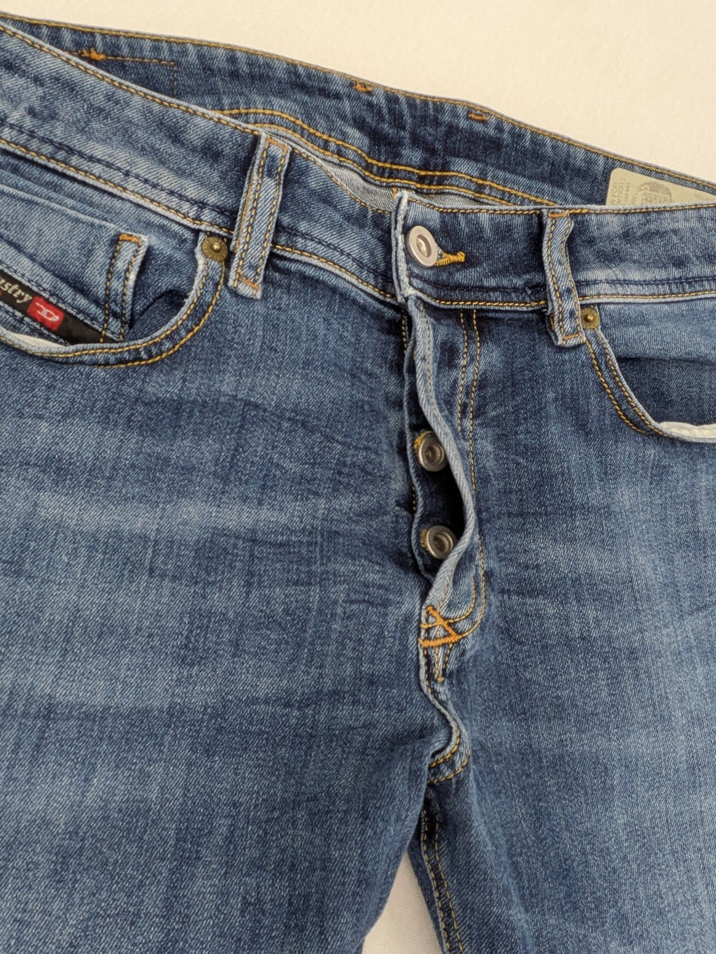 Diesel blue slim skinny jeans with logo patch and stretch denim material.